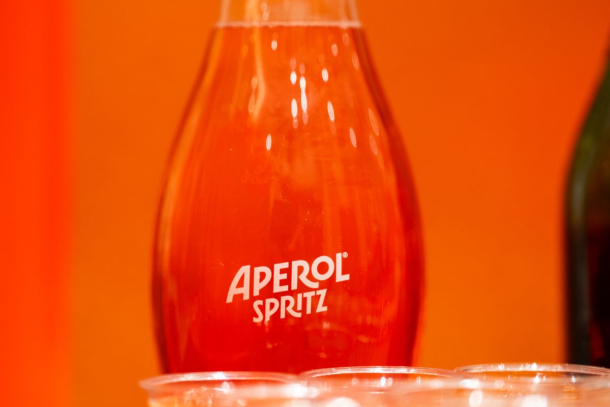 A spritz carafe against a bright orange backdrop