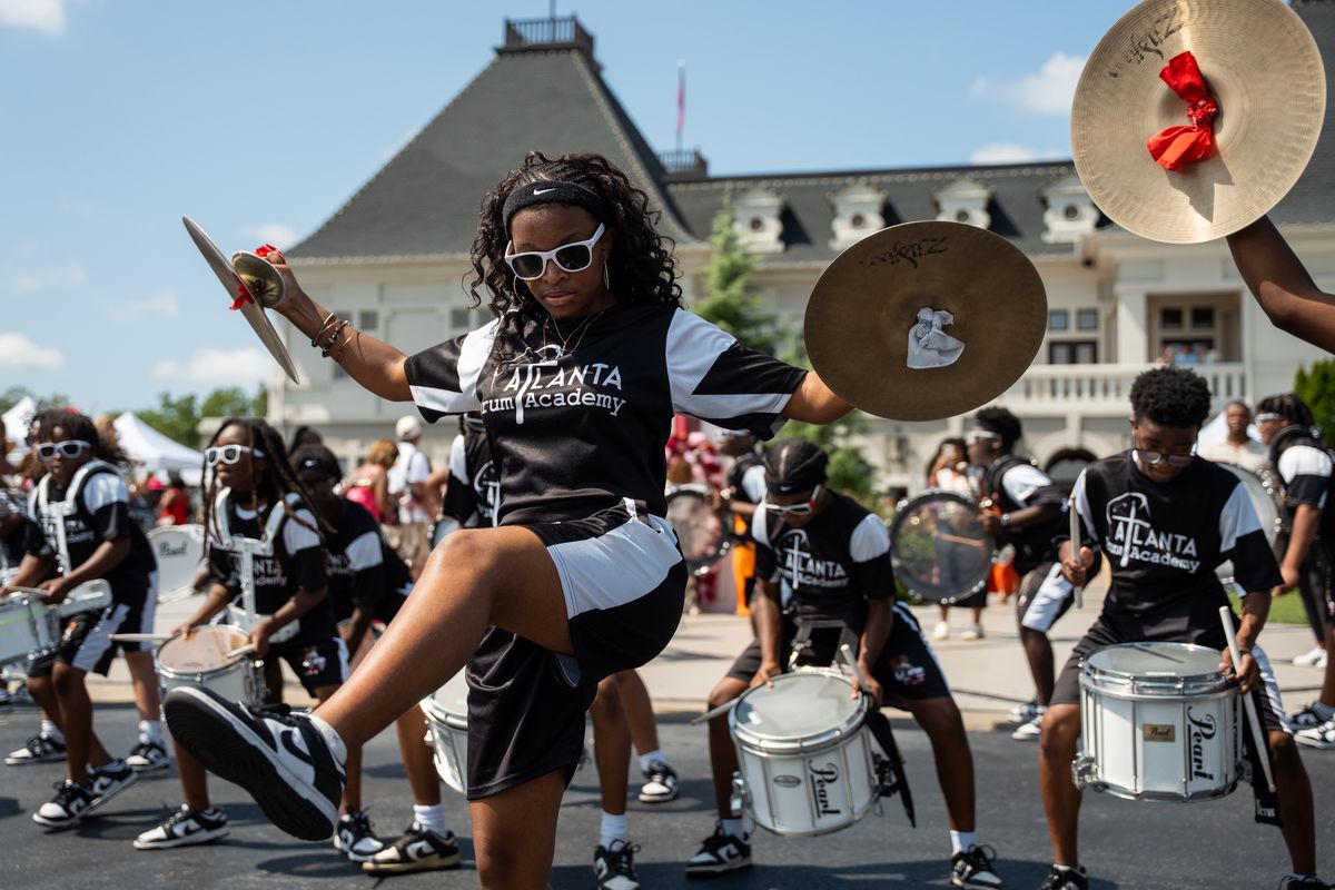 A drumline performing in front of the château