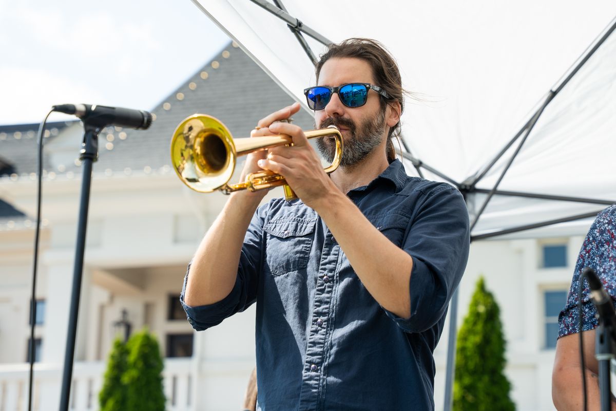 A trumpet player performing on the festival stage